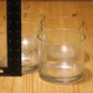 Three clear glass tumblers on a light wood surface next to a black ruler for scale.