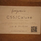 A square paper label for MidWest Fragrance Company's C55/Caluxxe Coconut Tart Wax, displayed on a brown cardboard background.