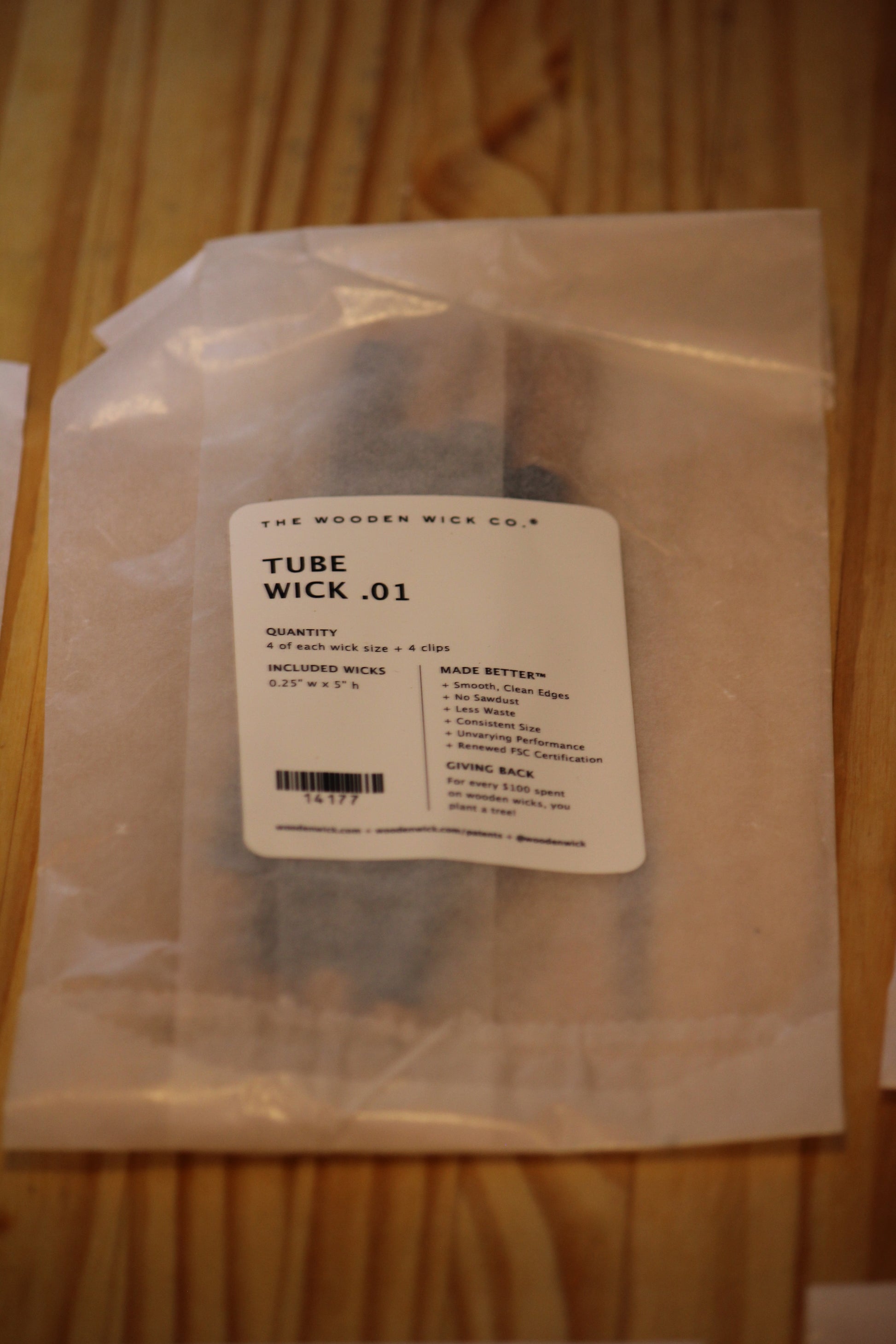 A packaged woodenwick tube product labeled 'TUBE WICK .01' by The Wooden Wick Co.