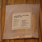 A clear plastic bag containing wood wicks, featuring a white label that reads 'DAFFODIL YELLOW X WICK .02' from 'The Wooden Wick Co.
