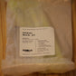 A packaged bundle of spiral wicks from The Wooden Wick Co. in a clear plastic bag with a white label, resting on a wooden surface.