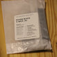 A sealed plastic bag of wood wicks labeled 'THE WOODEN WICK CO. RAVEN BLACK X WICK .