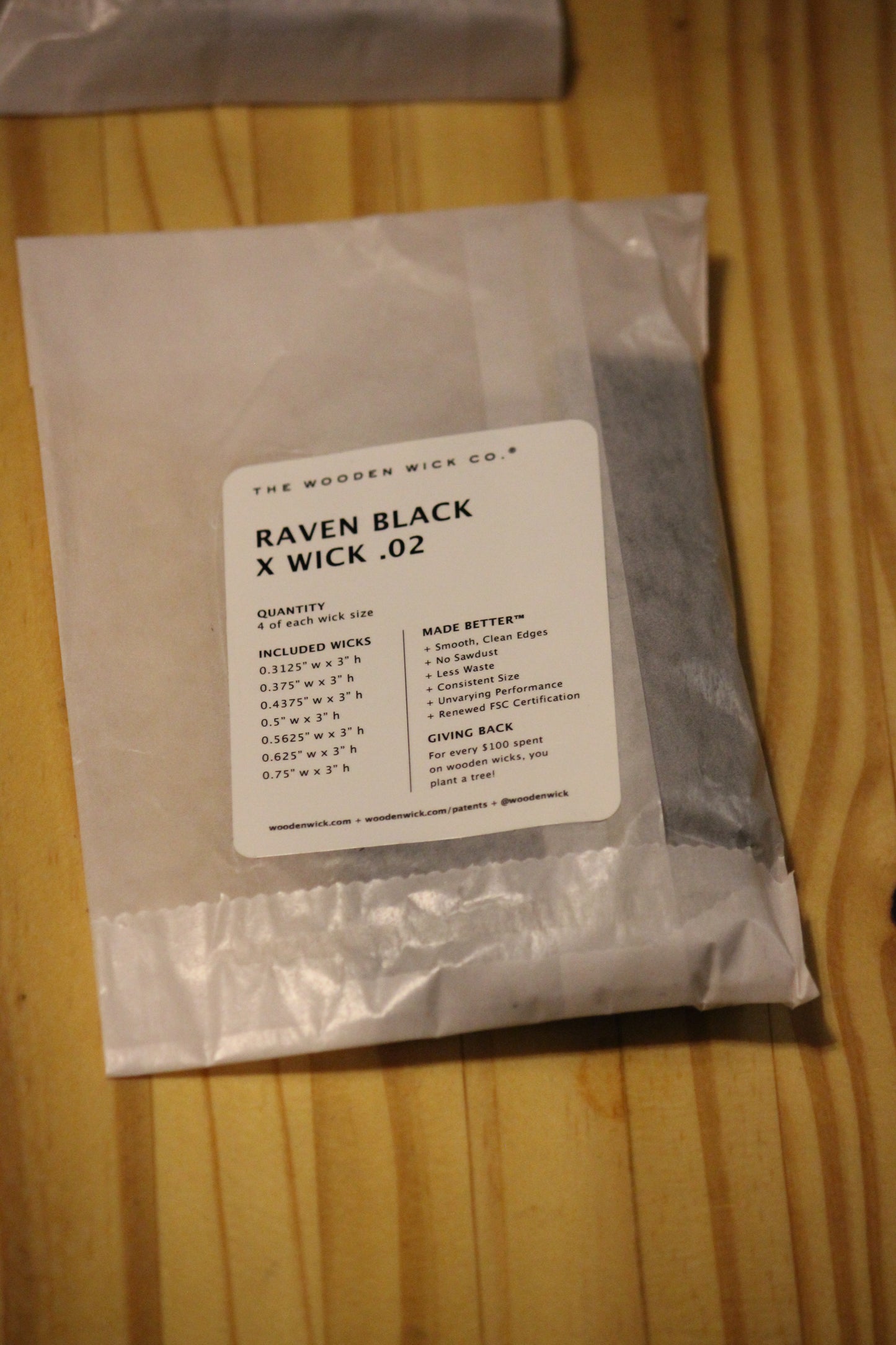 A sealed plastic bag of wood wicks labeled 'THE WOODEN WICK CO. RAVEN BLACK X WICK .