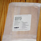 A clear plastic bag containing wooden wicks, sealed with a white label that reads 'THE WOODEN WICK CO. WHISPER BOOSTER WICK .
