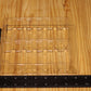 A clear plastic clamshell tray with internal molded inserts, shown on a light wood surface with a black ruler measuring its dimensions.
