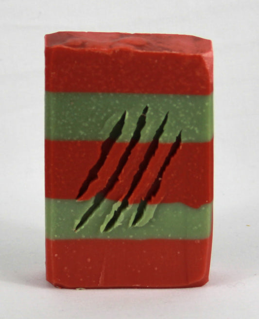 Red and green striped soap bar with 4 slash marks across front