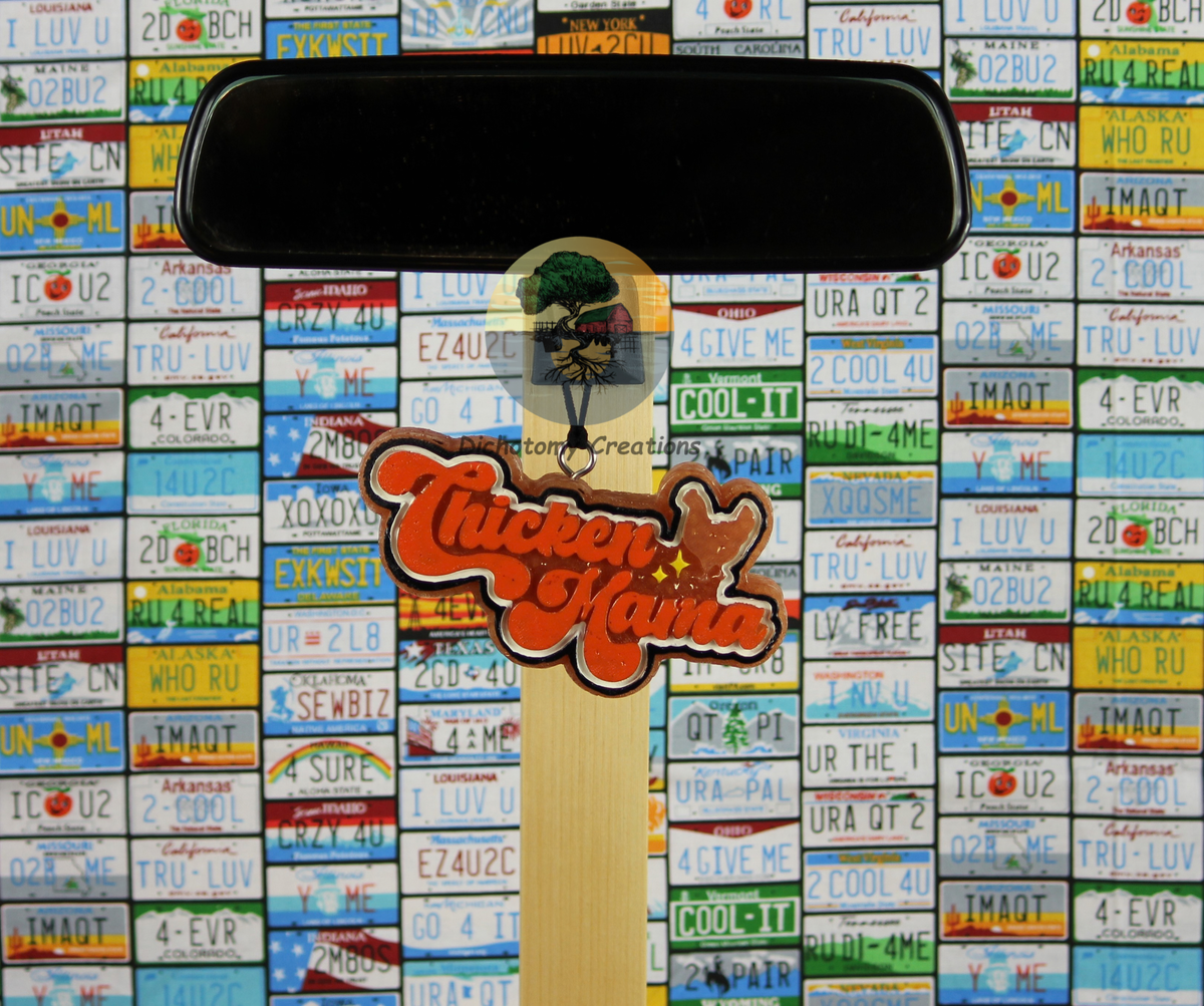 A hanging freshie, brown with orange paint with "Chicken Mama" printed, shown against a background of license plates.