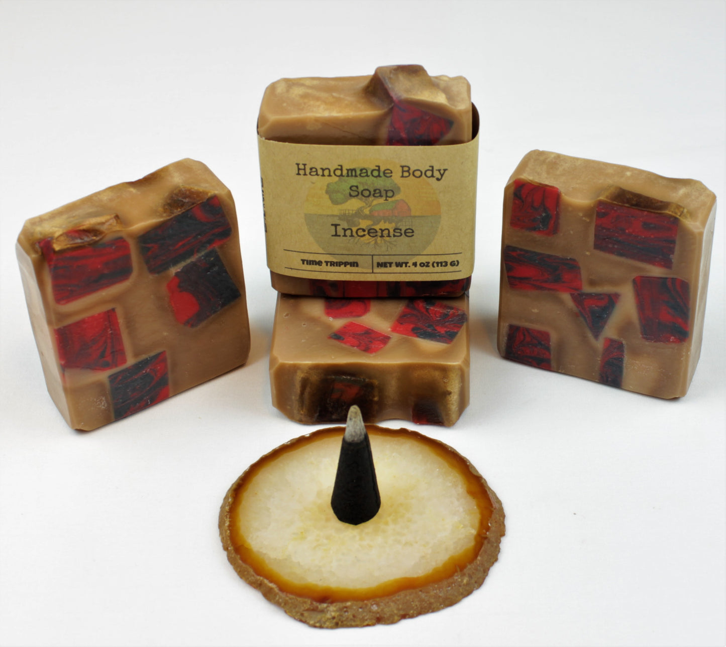 Four 4oz Incense soap bars, positioned around a burning incense cone. 