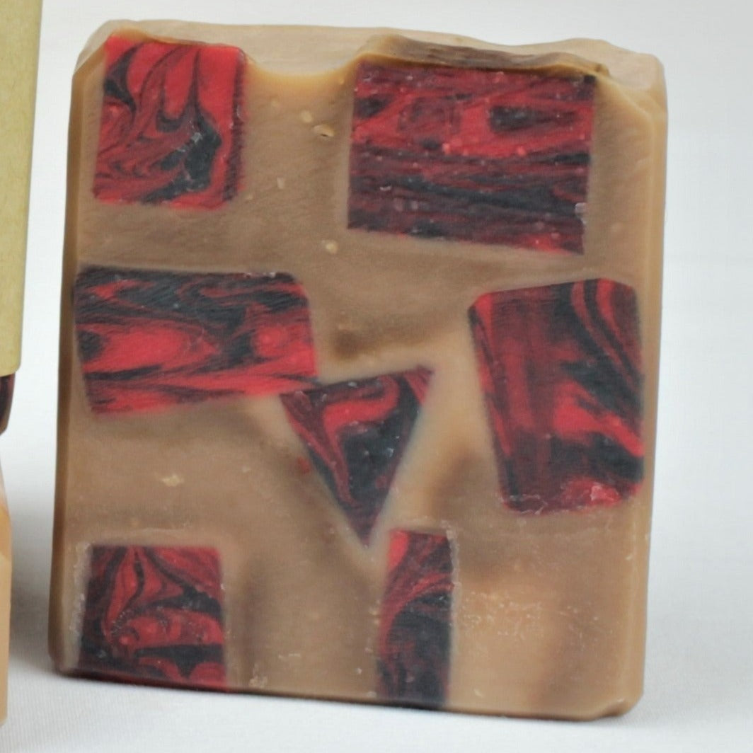 One 4oz bar of Incense, unlabeled.  Tan soap bar scented in Nag Champa with imbedded pieces of red and black swirled soap scented in Dragon's Blood. 