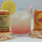 Four 4oz handmade bars of watermelon lemonade soap, pictured with a glass of pink lemonade