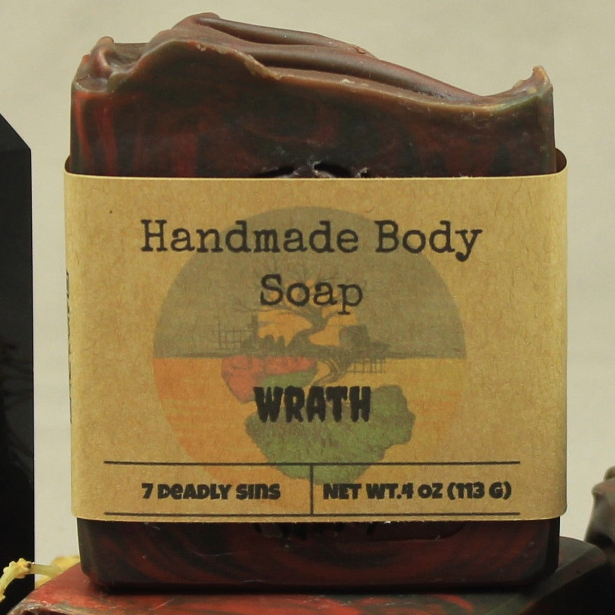 Wrath handmade soap, black and red swirls, labeled. Scented in dragon's blood and bonfire